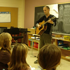 Gregg demonstrates songwriting skills to the class