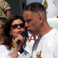 Lori Anna Reid wears shades to protect her eyes from the glare off Gregg's newly-shorn head as they sing the National Anthem